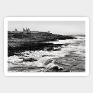 Rough waves hit the rocks near Dunstanburgh castle in Northumberland, UK Sticker